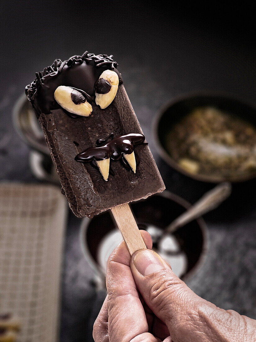 Homemade chocolate ice cream on a stick with Halloween decoration