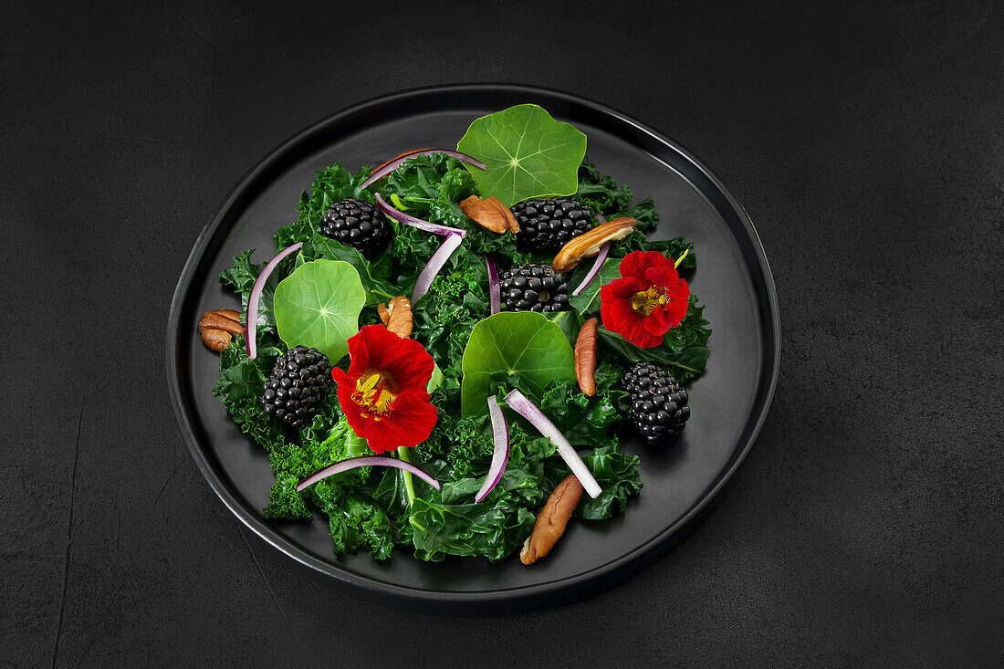 Kale salad with blackberries, nasturtium and pecans