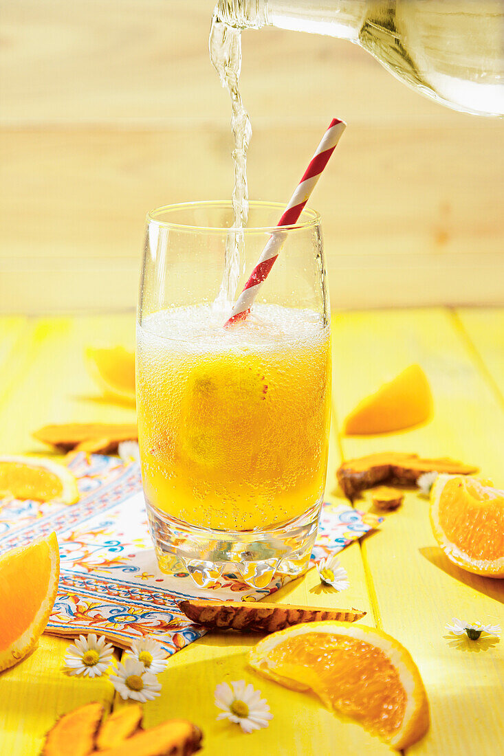 Orange juice in a glass with paper straw