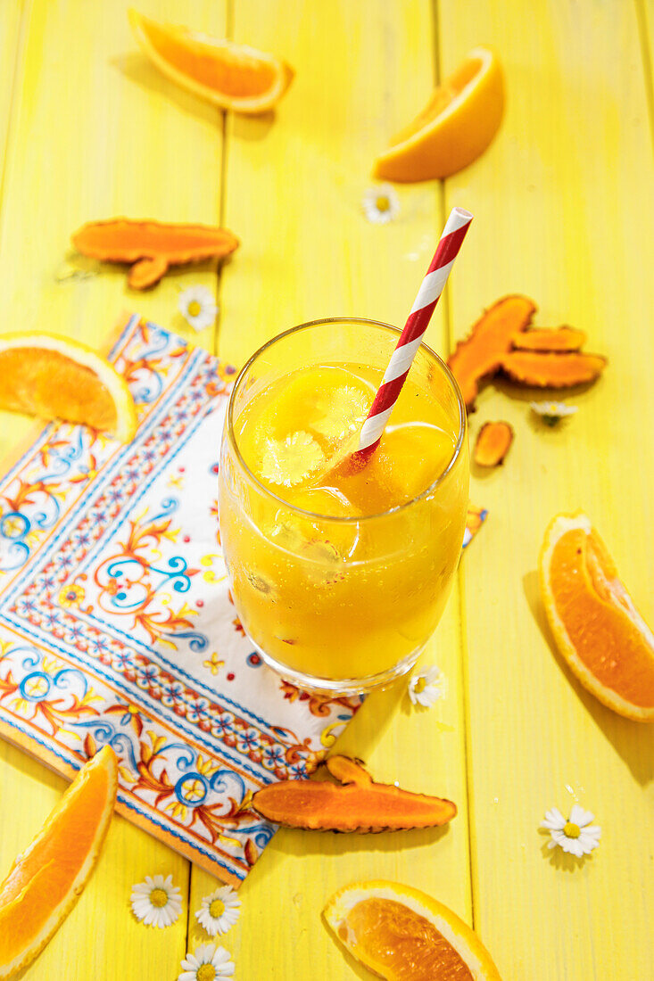 Orange juice in a glass with paper straw