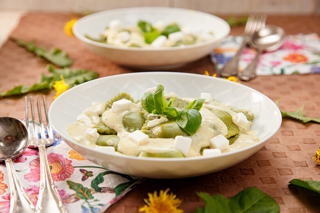 Dandelion ravioli with feta cheese and cream sauce