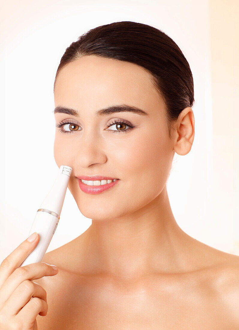 Young woman doing facial treatment