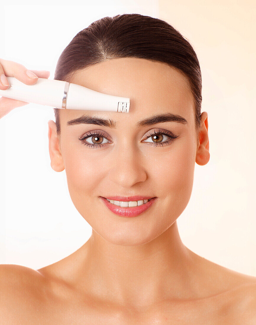 Young woman doing facial treatment