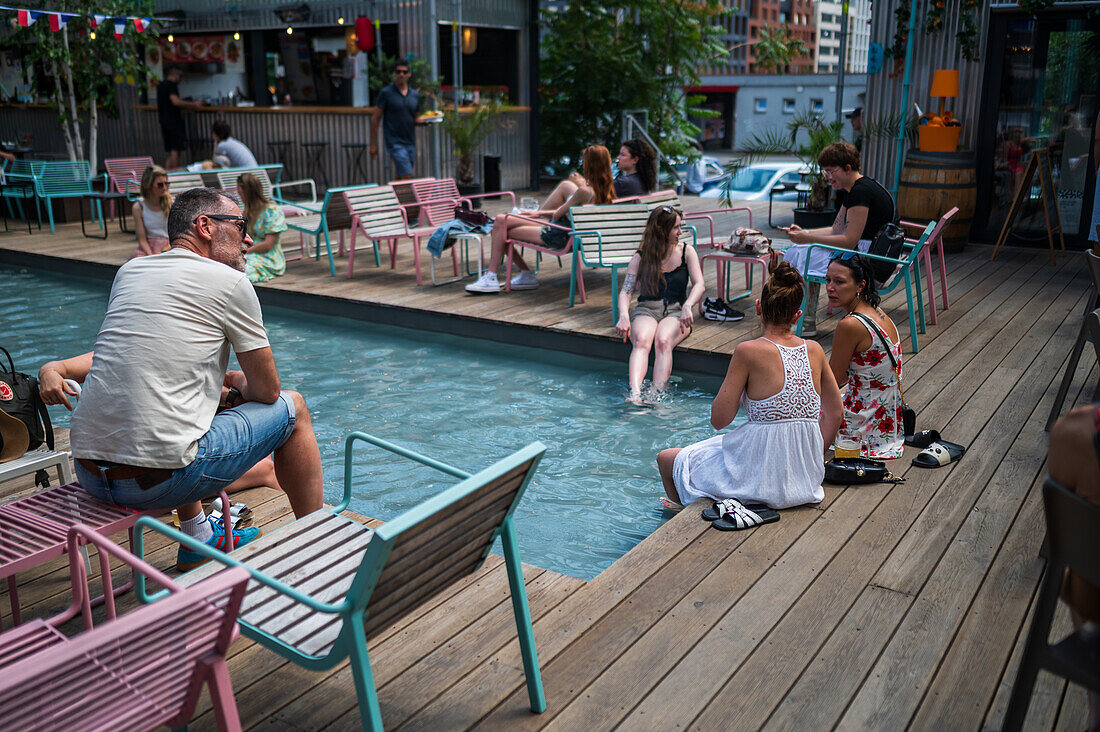 Clients refresh by the pool at Manifesto Market, a must-visit cultural experience in the heart of Prague with pop-up design retail experience bars and high-quality street food.