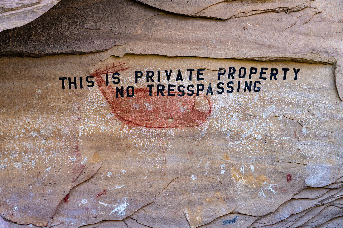 Ein prähispanisches Felsbild der Fremont-Kultur der amerikanischen Ureinwohner im Nine Mile Canyon, Utah. Diese Botschaft über dem Piktogramm in der Rasmussen-Höhle wurde vom früheren Landbesitzer gemalt, wodurch die alte Felskunst dauerhaft verunstaltet wurde. Die Stätte ist jetzt öffentliches Eigentum