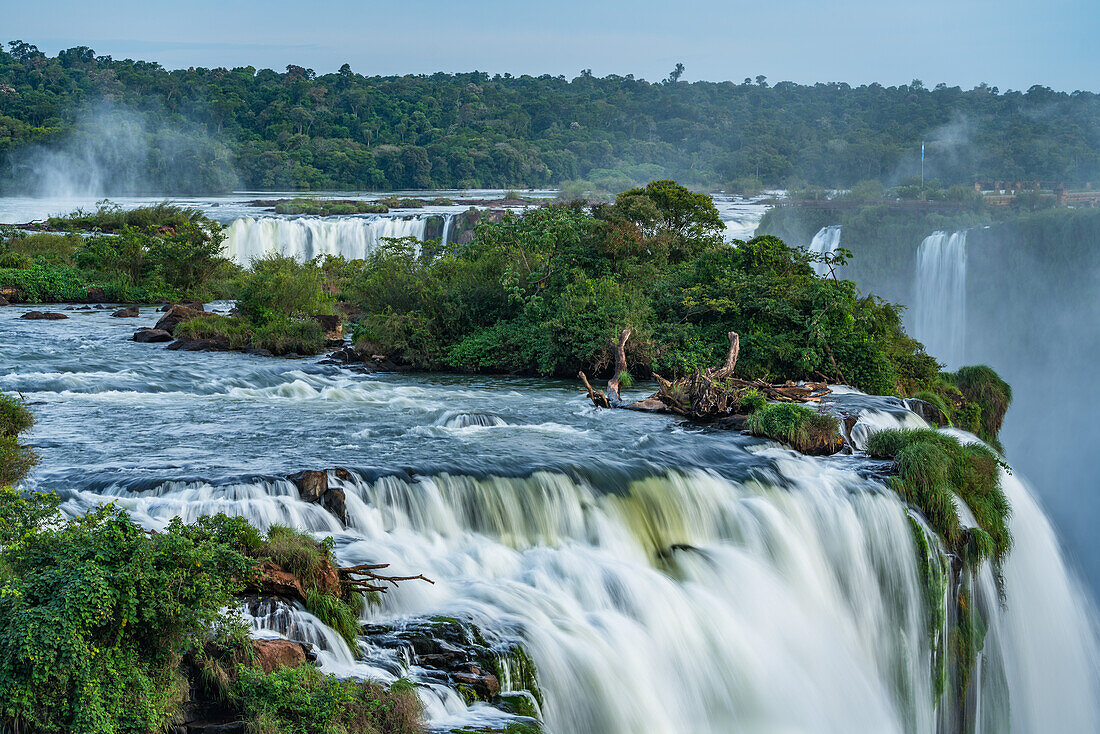 Iguazu Falls National Park in Argentina and Brazil. A UNESCO World Heritage Site. In the foreground is the top of the Floriano Waterfall, with the Devil's Throat or Garganta del Diablo with its mist plume just visibe above at left.