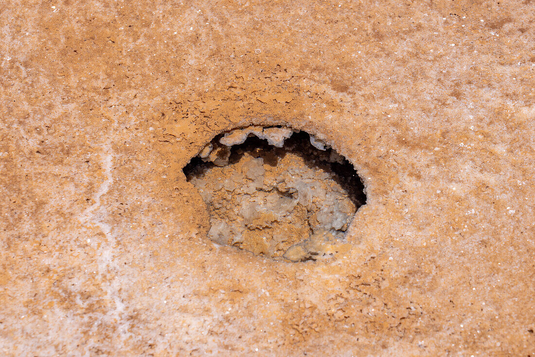 Close-up views of eroded cavities under water in the surface of the salt flats of Salinas Grandes in northwest Argentina.