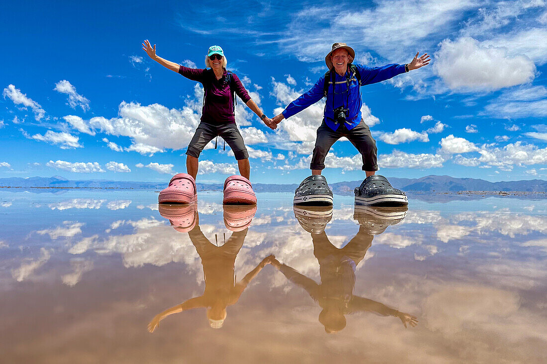 Tourists posing for humorous pictures on the salt flats of Salinas Grandes in northwest Argentina.