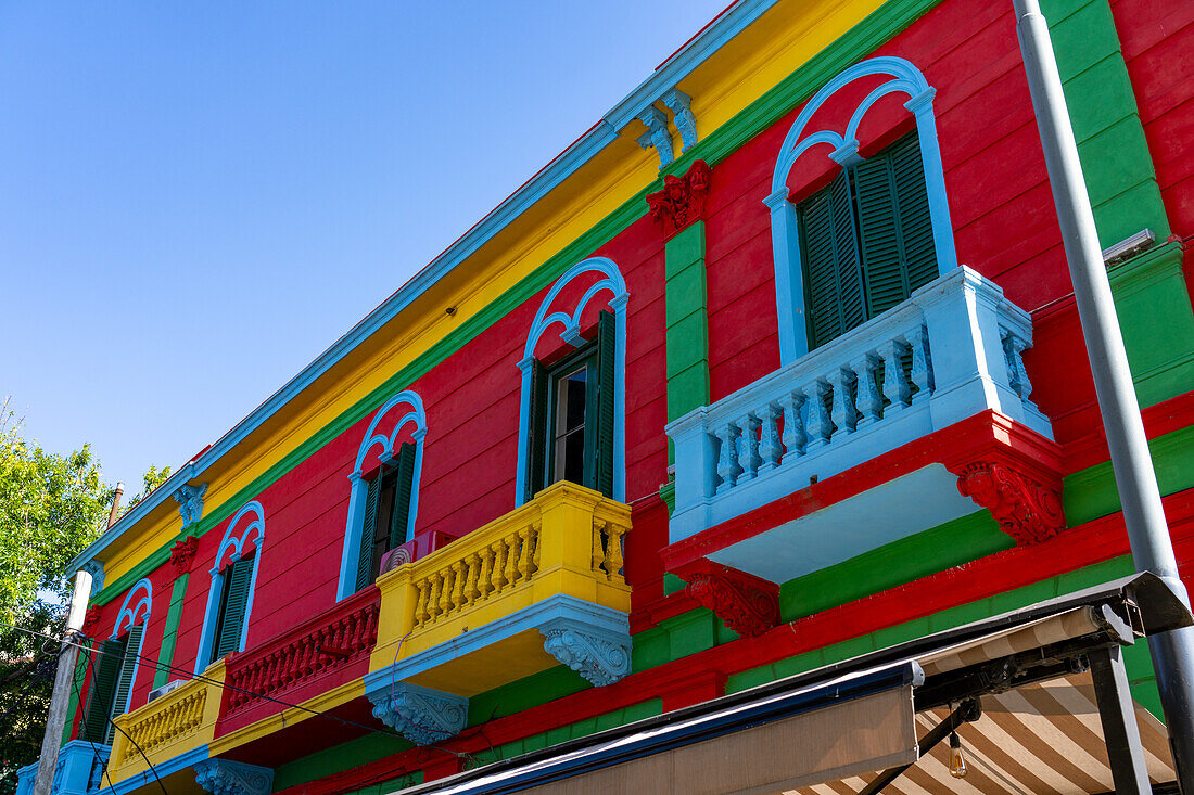 Colorfully painted balconies on buildings along Magallanes Street in Caminito, La Boca in Buenos Aires, Argentina.