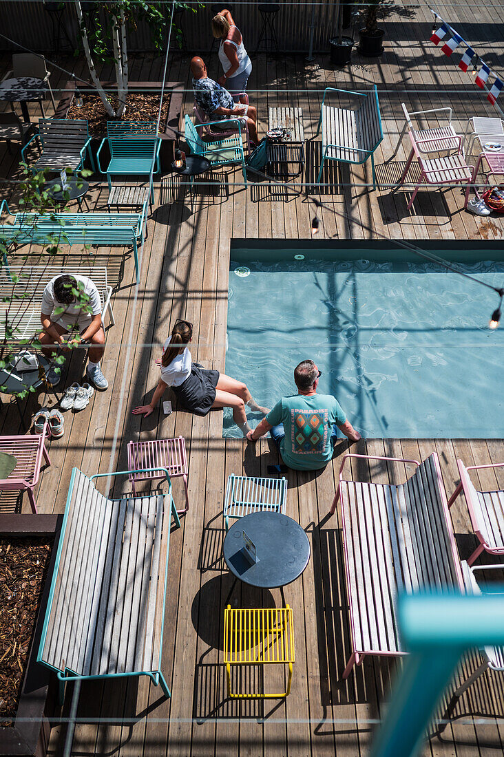 Clients refresh by the pool at Manifesto Market, a must-visit cultural experience in the heart of Prague with pop-up design retail experience bars and high-quality street food.