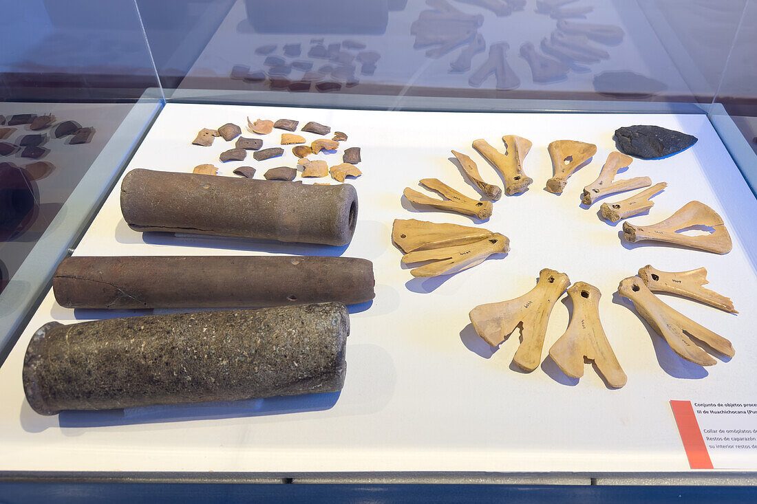 Pre-Hispanic grave goods in the Dr. Eduardo Casanova Archeology Museum in Tilcara, Argentina. Found in Huachichocana Cave III near Purmamarca. Included are a necklace made of llama bones and stone pipes with hallucenogenic residue inside.