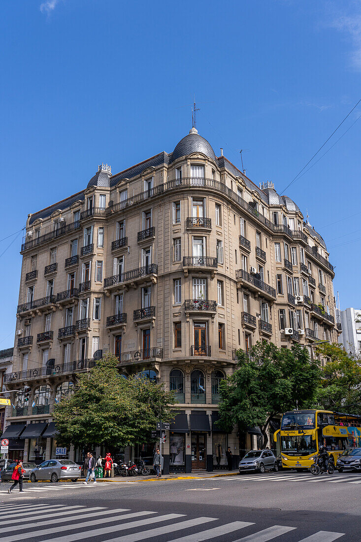 A vintage apartment building with shops on the ground floor on Avenida Belgrano & Ave. Balcarce. Buenos Aires, Argentina.