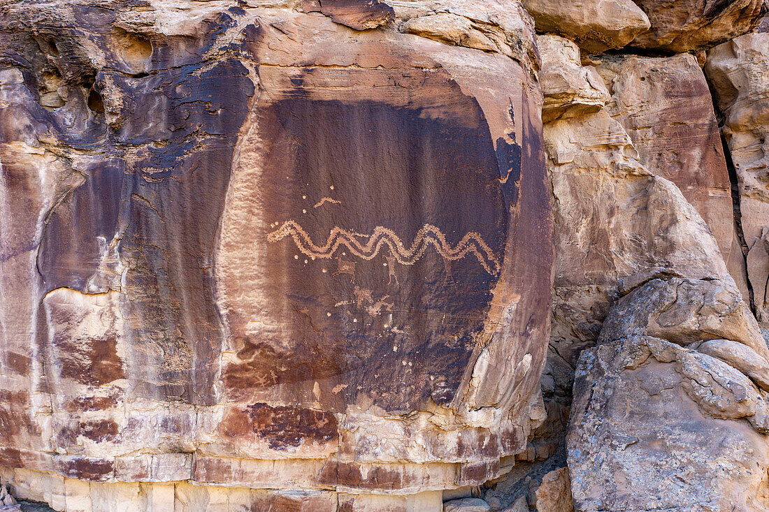 Aerial drone view of a pre-Hispanic Amerindian rock art petropglyph panel of the Fremont Culture in Nine Mile Canyon, Utah. A large snake is depicted on this panel.