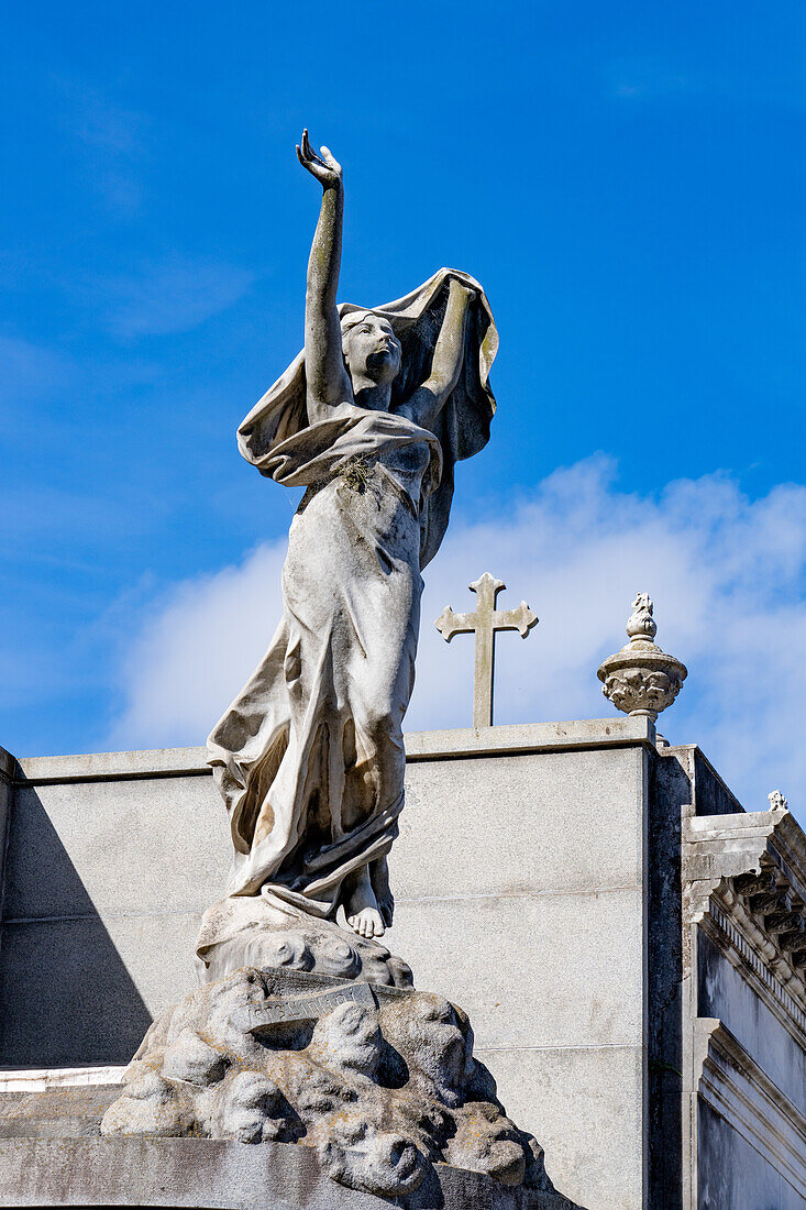 A statue of a woman on a mausoleum in the Recoleta Cemetery in Buenos Aires, Argentina.