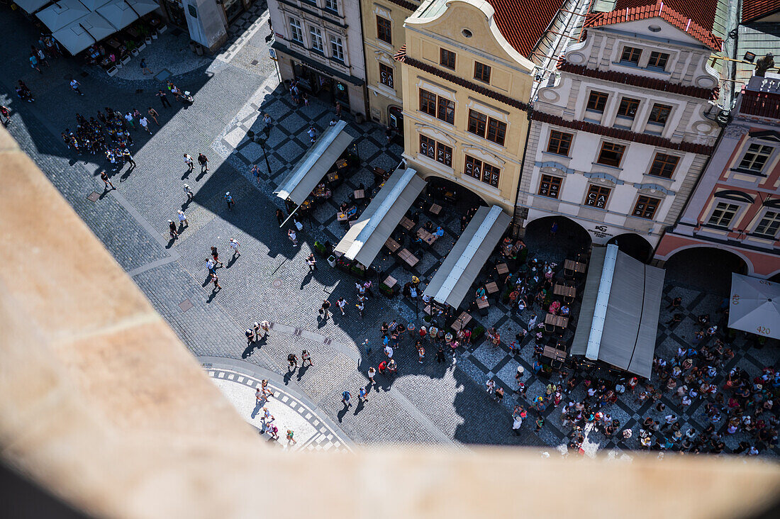 View of tourists, shops and restaurants from the tower of the Old Town Hall in Prague