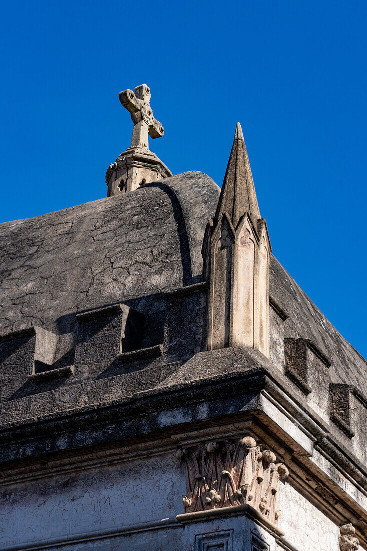 A cross on an elaborate tomb or mausoleum in the Recoleta Cemetery, Buenos Aires, Argentina.