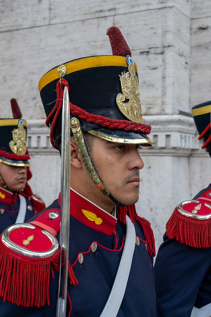 The military honor guard marching from the tomb of San Martin in the Cathedral to the Casa Rosada in Buenos Aires, Argentina. The soldiers are members of the Ayacucho Squadron of the Regiment of Horse Grenadiers.