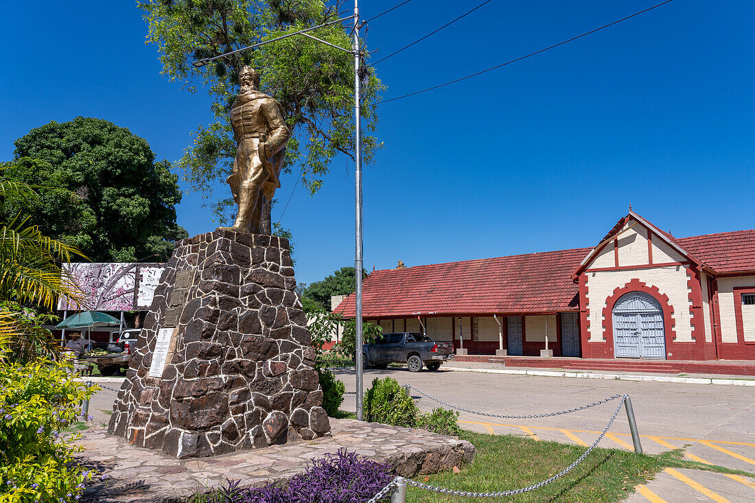 Bronze memorial statue of General Miguel de Guemes in front of the old railroad station in Tartagal, Argentina.