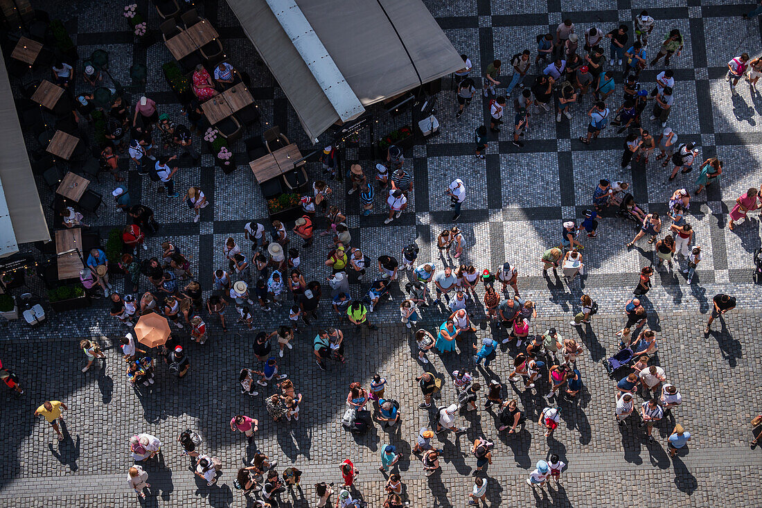 View of tourists, shops and restaurants from the tower of the Old Town Hall in Prague