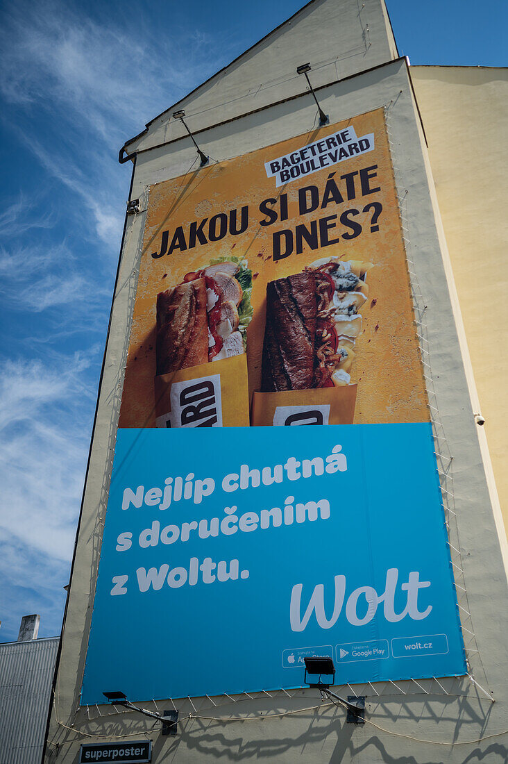 Wolt ad on building wall in Prague