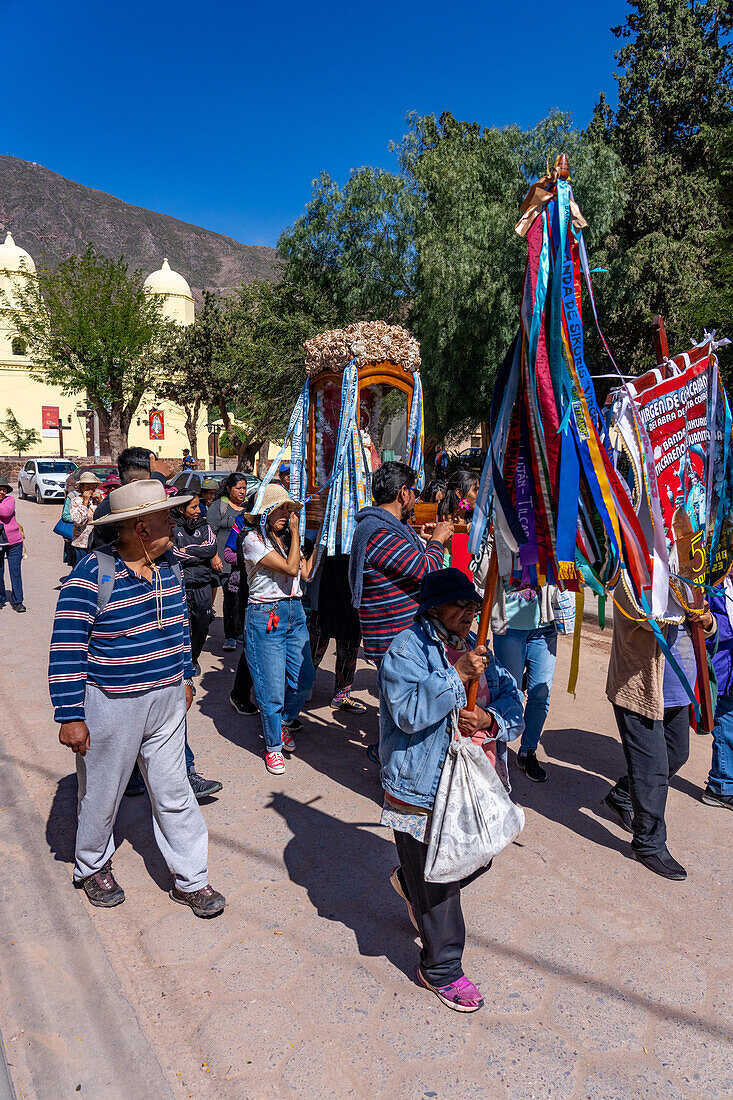 Parishioners carry a statue of the Virgin in a religious procession in the town of Tilcara, Argentina.