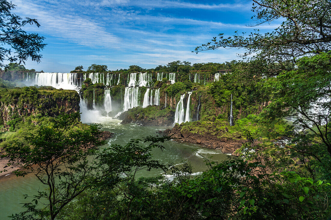 The powerful San Martin Waterfall at left with Mbigua Falls at center in Iguazu Falls National Park in Argentina. A UNESCO World Heritage Site.