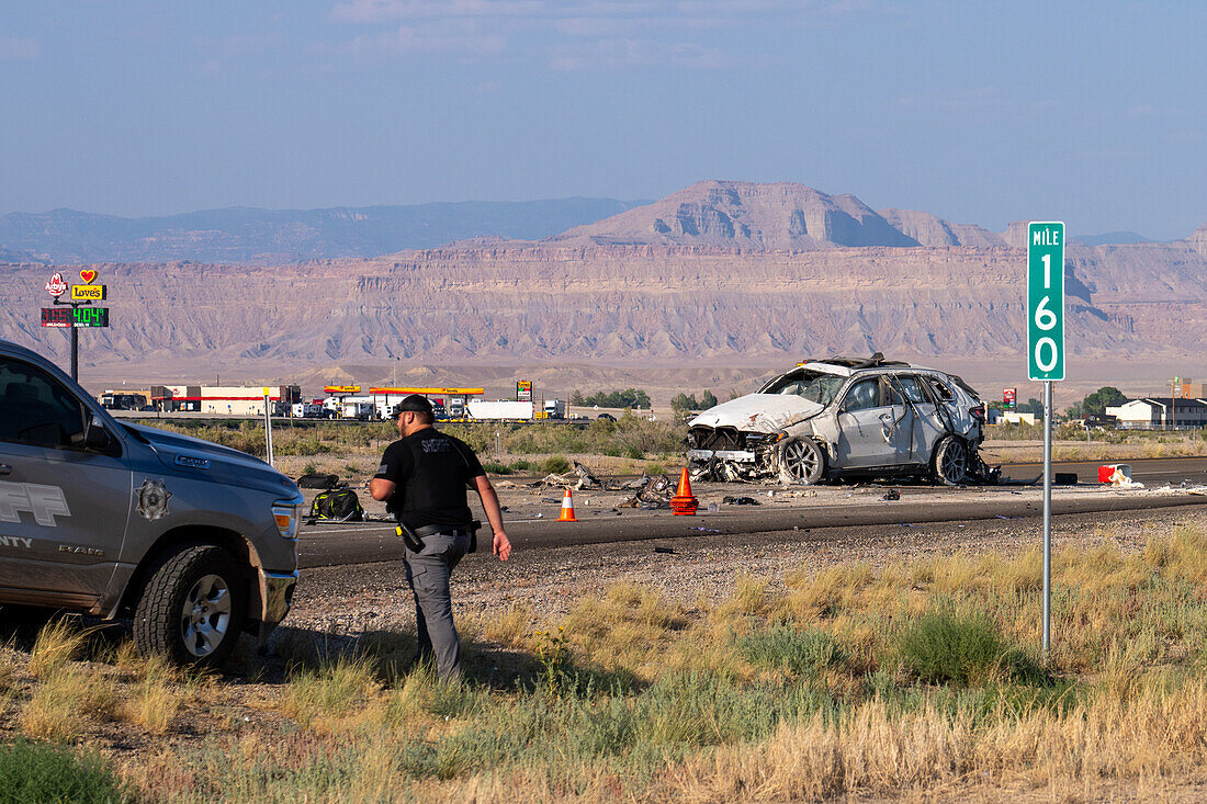 Law enforcement officers investigate a deadly auto crash in Utah.