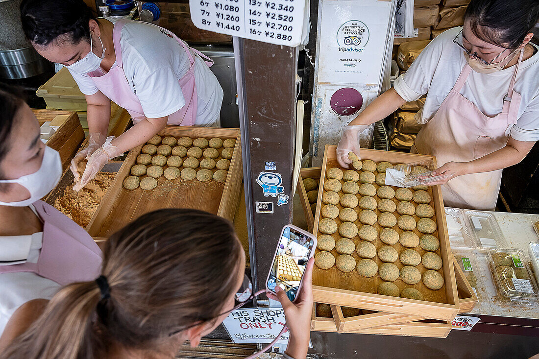 Selling the traditional Daifuku in Nakatanidou shop, made of soft rice cake (mochi) fill with sweet bean paste, in Nara Japan.