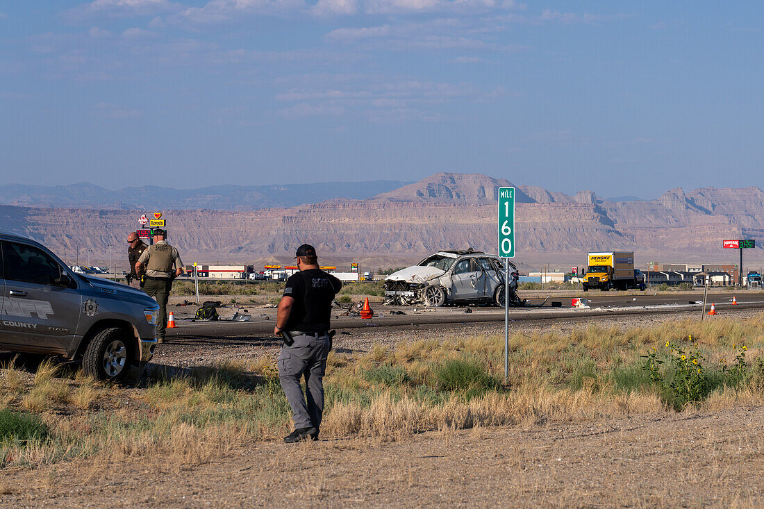 Law enforcement officers investigate a deadly auto crash in Utah.