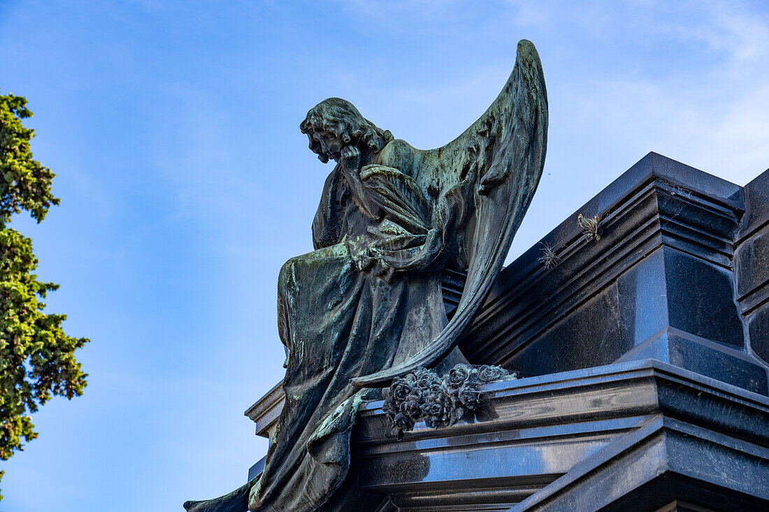 An angel statue on a mausoleum in the Recoleta Cemetery in Buenos Aires, Argentina.