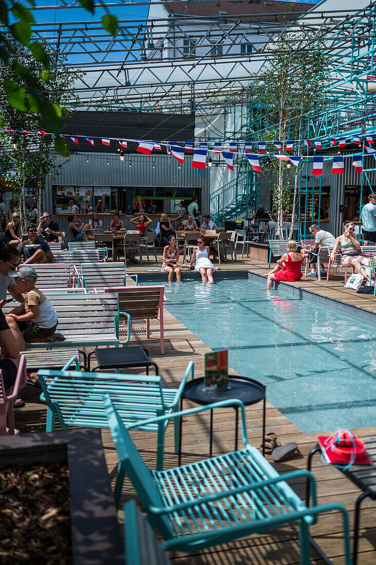 Clients refresh by the pool at Manifesto Market, a must-visit cultural experience in the heart of Prague with pop-up design retail experience bars and high-quality street food.