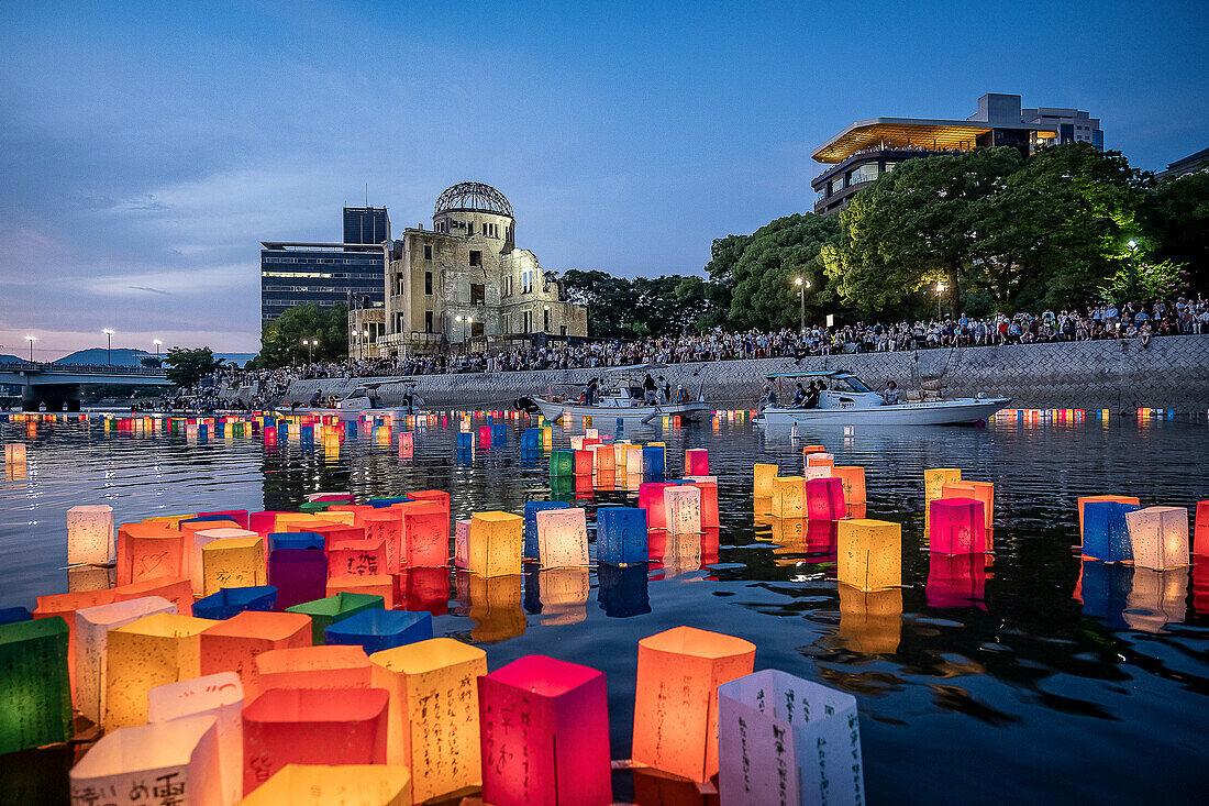 People float lanterns on the river, in front of Atomic Bomb Dome with floating lamps on Motoyasu-gawa River during Peace Memorial Ceremony every August 6 in Hiroshima, Japan