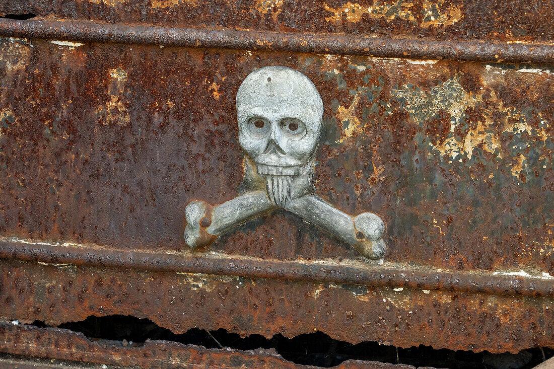 A skull and crossbones on a rusting tomb or mausoleum in the Recoleta Cemetery, Buenos Aires, Argentina.