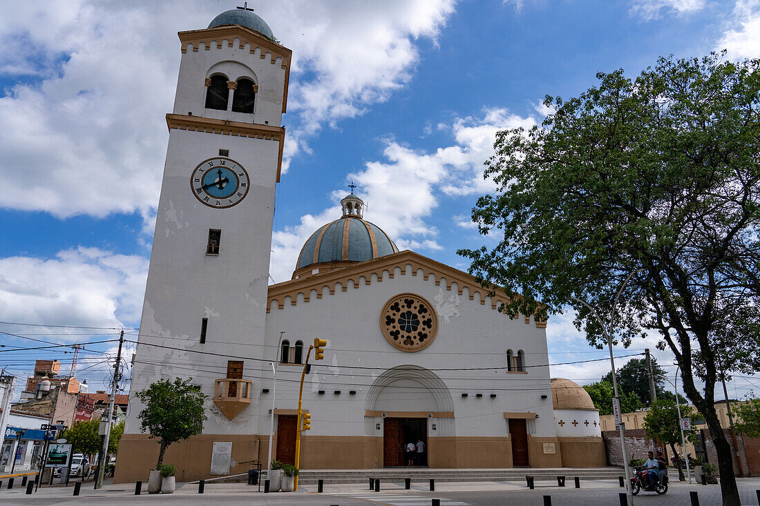 The exterior of the Church of Our Lady of the Rosary with its single bell tower with a clock. Monteros, Argentina.