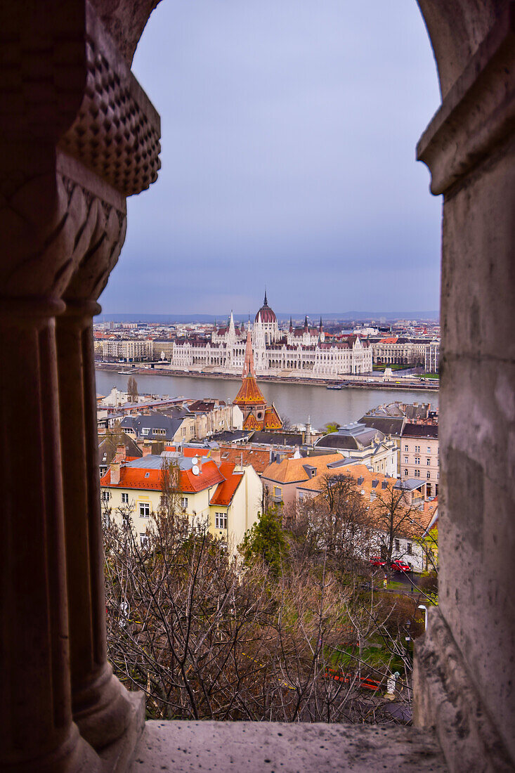 View of Parliament building, Chain Bridge and Danube River through old columns, Budapest, Hungary, Europe