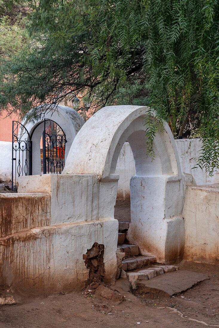 A arched gateway in the atrium of the Church of Santa Rosa de Lima in Purmamarca, Argentina.