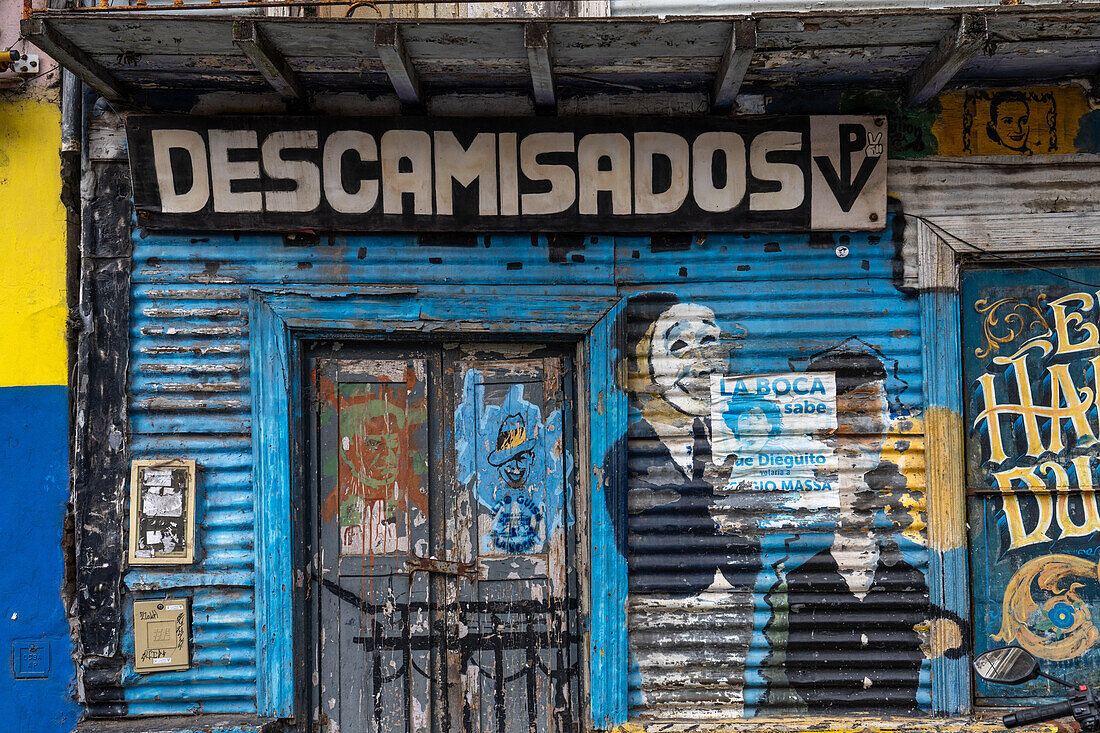 A street art mural painted around a weather door in a building in Caminito, La Boca, Buenos Aires, Argentina.