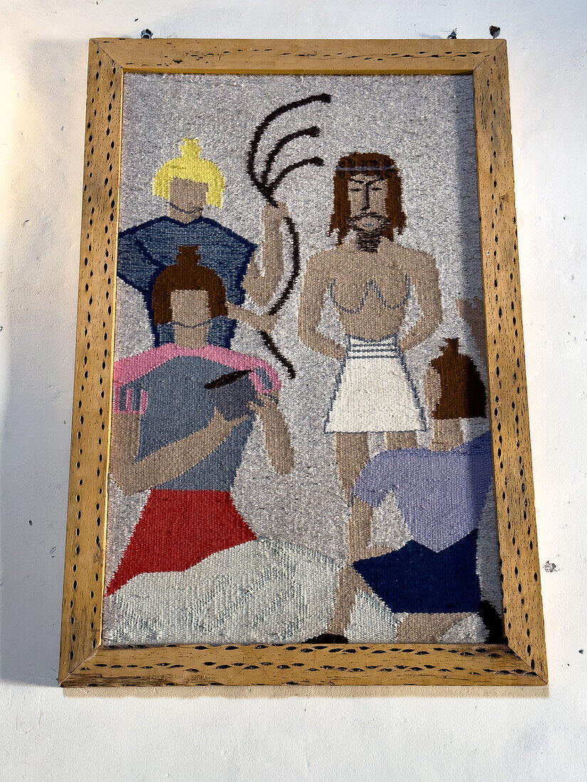 A woven tapestry of a Station of the Cross with a cactus-wood frame in the San Pedro de Nolasco church in Molinos, Argentina.