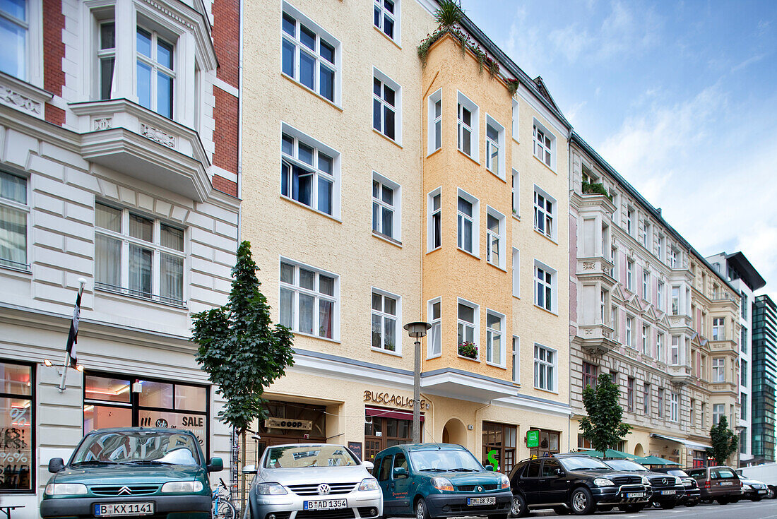 Berlin, Germany, July 24 2009, Explore Roch Street in the Scheunenviertel district, featuring distinct Berlin buildings and parked cars under a clear sky.