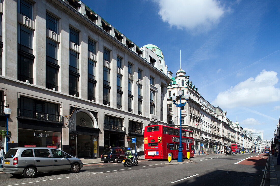 London, UK, May 2 2009, Red double decker buses travel along bustling Regent Street in Westminster, showcasing the vibrant atmosphere of London.