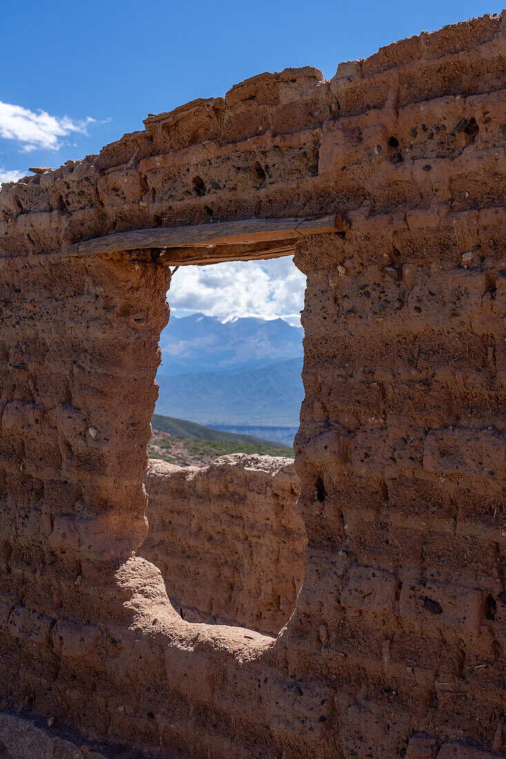 Adobe ruins at the Mirador de la Ventanita de los Valles Calchaquies between Cardones National Park & Payogasta, Argentina. The snow-capped Nevado de Cachi is framed by the doorway.