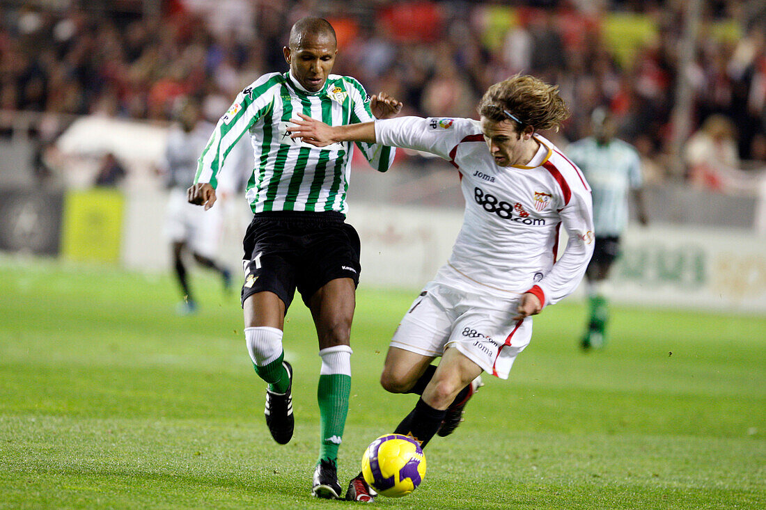 Seville, Spain, Feb 7 2009, Diego Capel navigates past Mehmet Aurelio in a tense moment during the Sevilla FC vs. Real Betis match on February 7, 2009.