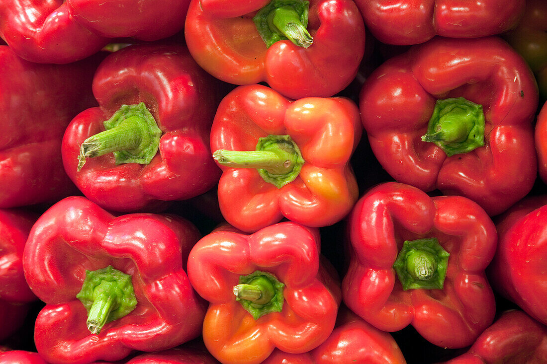 Bright red peppers are displayed at Mercat de la Boqueria, showcasing the fresh produce available in Barcelonas bustling market.