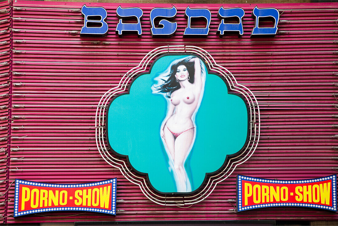 Barcelona, Spain, Sept 4 2008, A vibrant neon sign displays an alluring figure at an erotic venue on Paralelo Avenue in Barcelona, attracting attention from passersby.