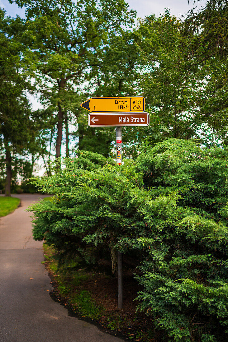 Sign in park indicates city center and Mala Strana, Prague