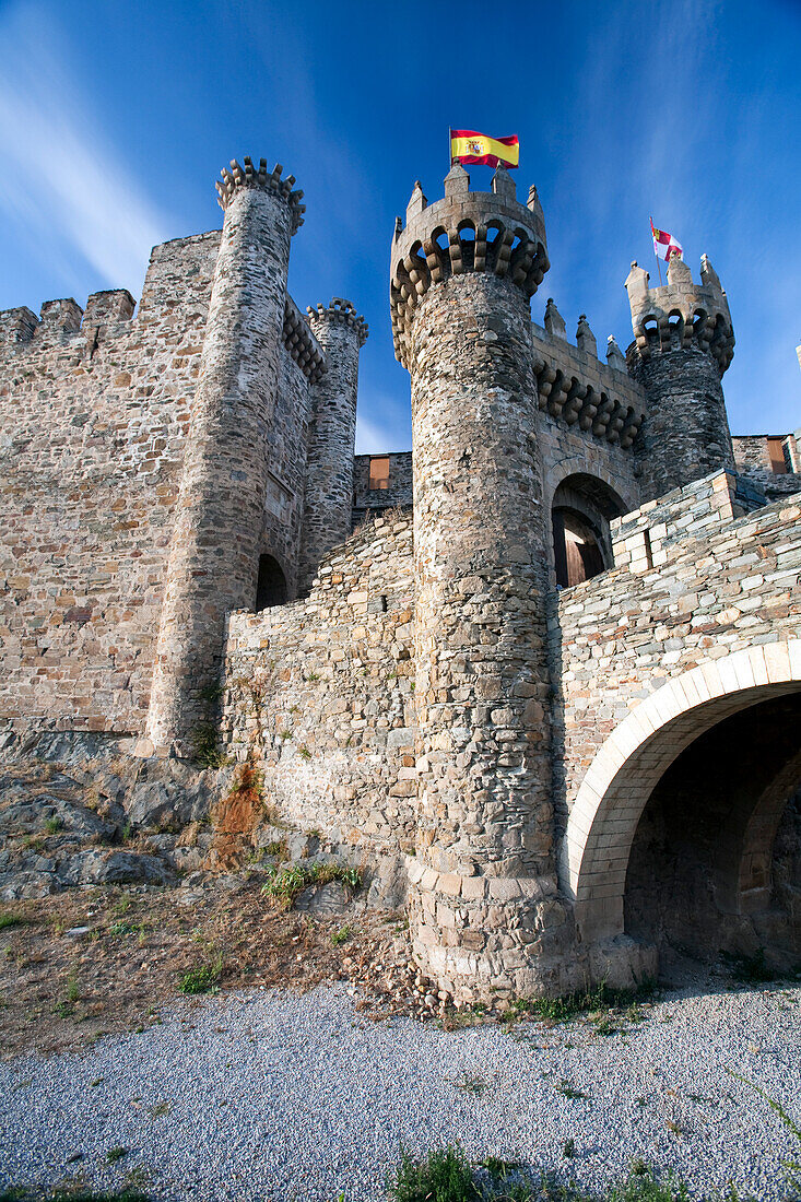 The majestic entrance of the Temple Castle showcases stone walls and towers, inviting visitors to explore its rich history in Ponferrada.