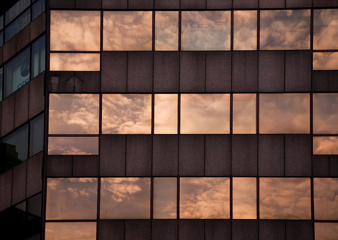 Barcelona, Spain, Sept 4 2008, The Banco Pastor building features reflections of a dramatic sky on its glass façade along Passeig de Gràcia in Barcelona.