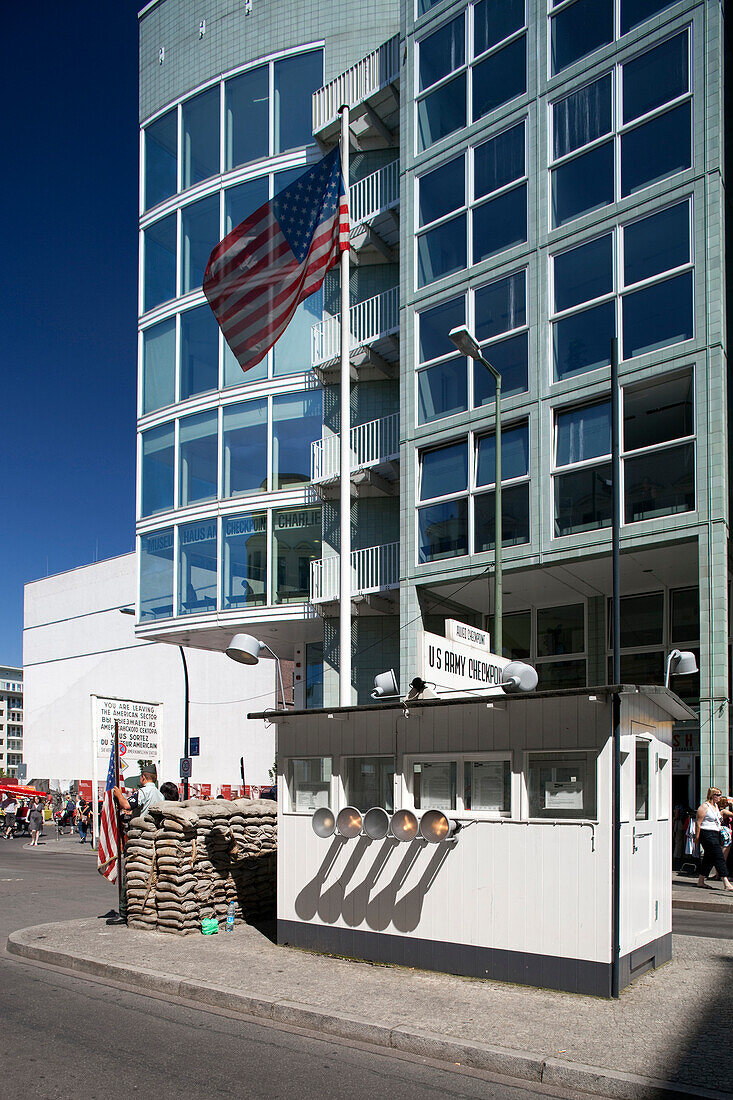 Berlin, Germany, July 27 2009, Checkpoint Charlie showcases its iconic booth and American flag, symbolizing the Cold War era in Berlin\'s Mitte district.