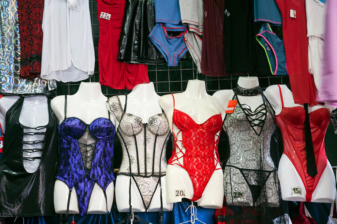 A vibrant display of various lingerie styles showcased at a stall in Mercado de San Antonio, Barcelona, inviting shoppers to browse.