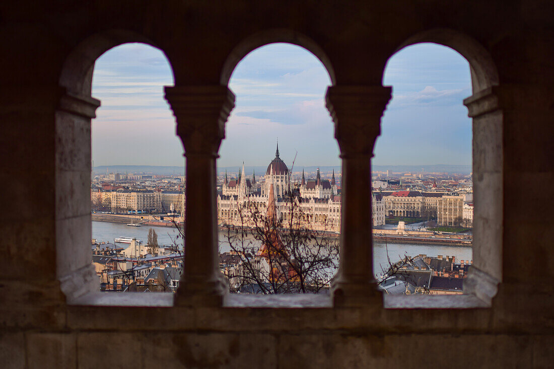 View of Parliament building, Chain Bridge and Danube River through old columns, Budapest, Hungary, Europe